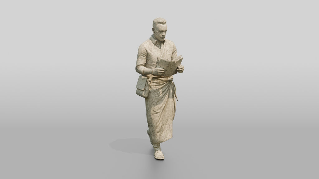 African Man Reading a Map in a Wrap Skirt