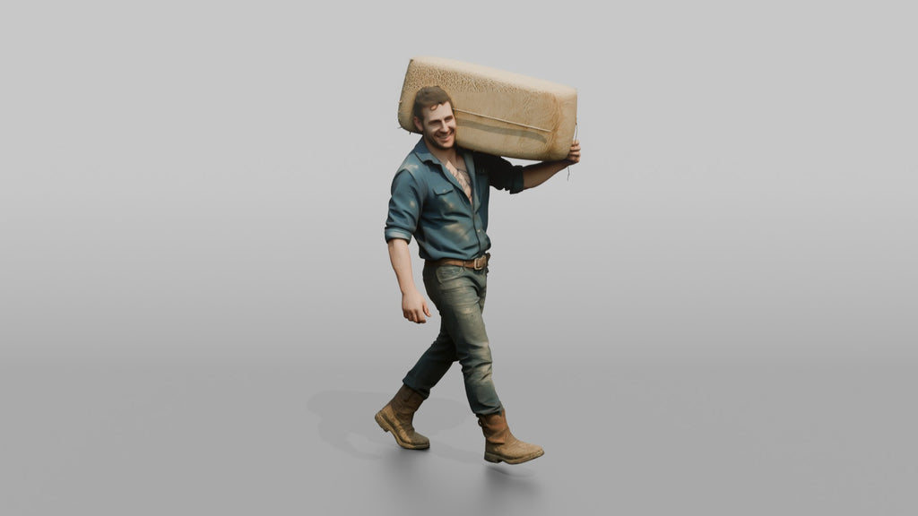 Farmer Carrying Large Bale Of Hay Over