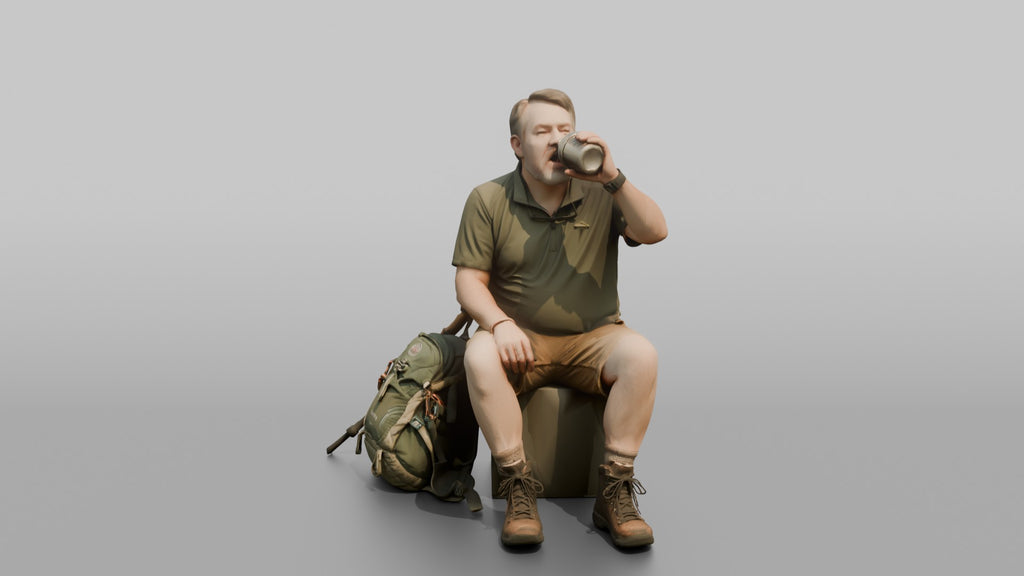 Hiker Sitting and Drinking from a Canteen
