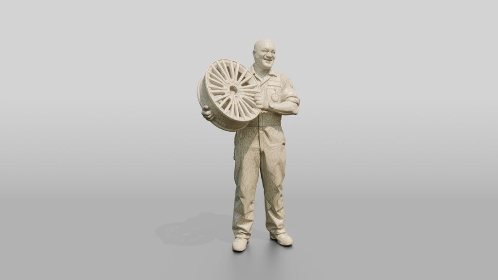 Mechanic Lifting an Alloy Wheel