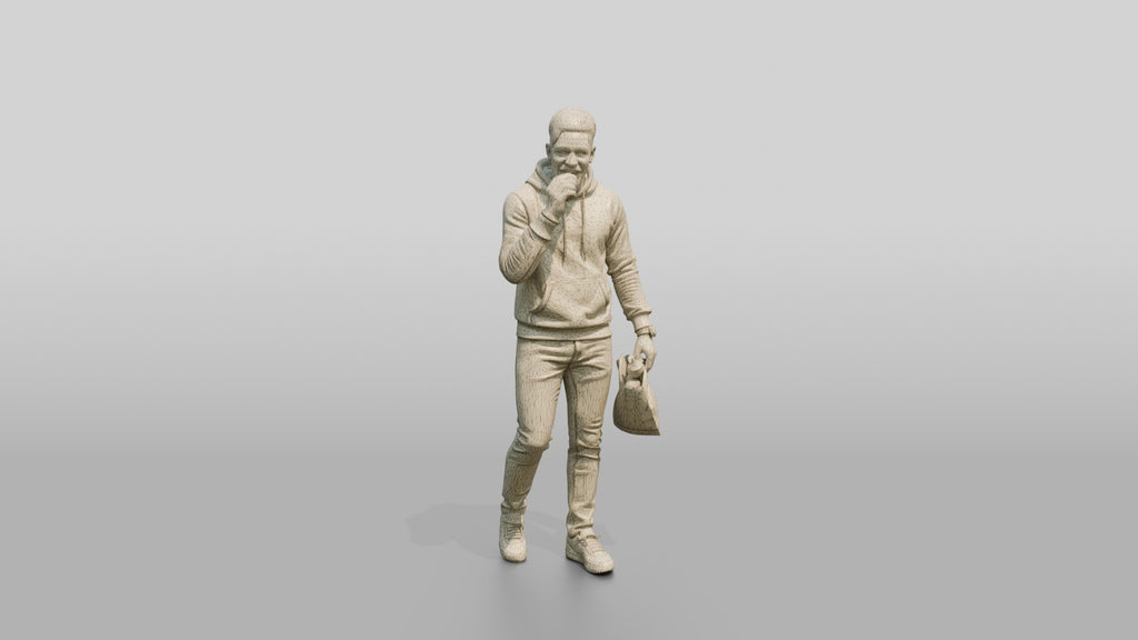 African Man in Print-Sleeve Hoodie Eating a Pastry