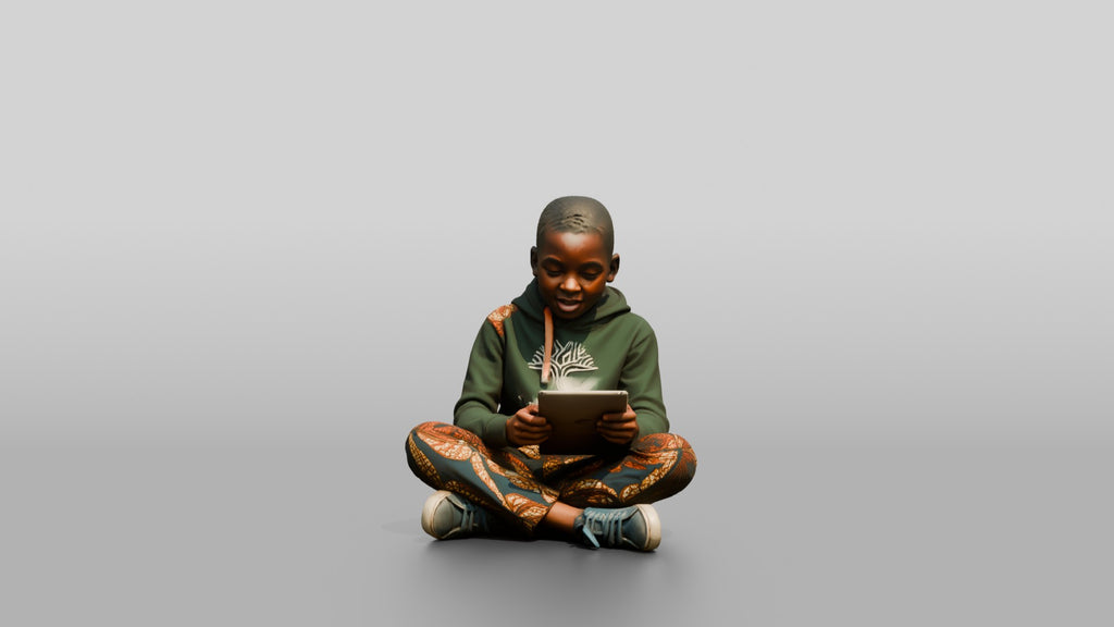 African Boy Sitting Cross-Legged with a Tablet
