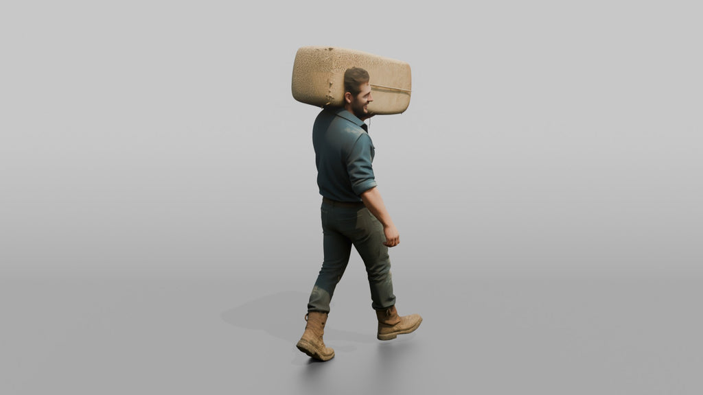 Farmer Carrying Large Bale Of Hay Over