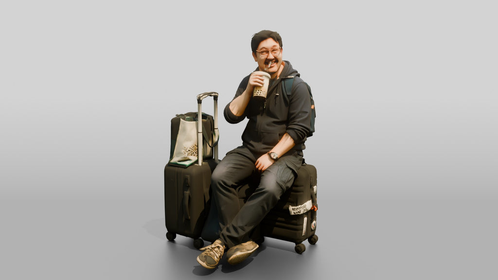 Plus-Size Asian Man Seated on Suitcase Drinking Bubble Tea